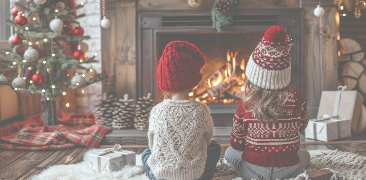 holiday visa 2024 MAIN children by a cozy fireplace at christmastime